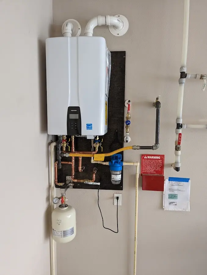 Professional plumber installing copper piping in a Woodfield home